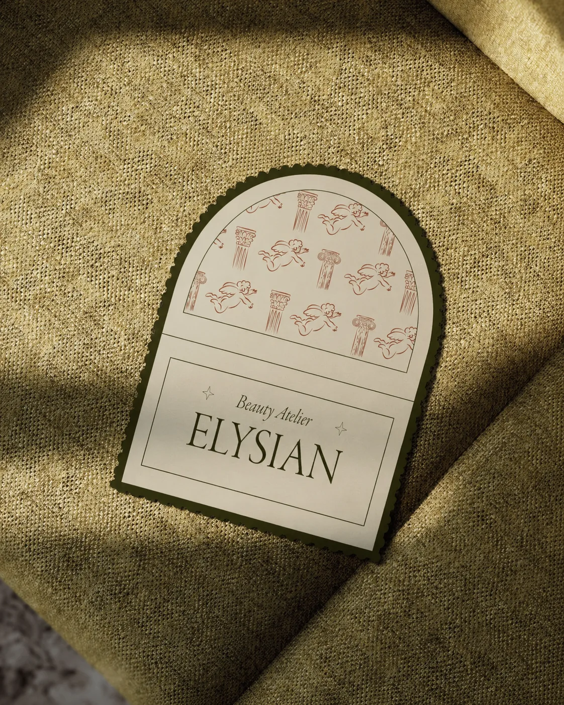 Elysian arched label photographed on olive fabric